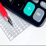 calculator and red pen